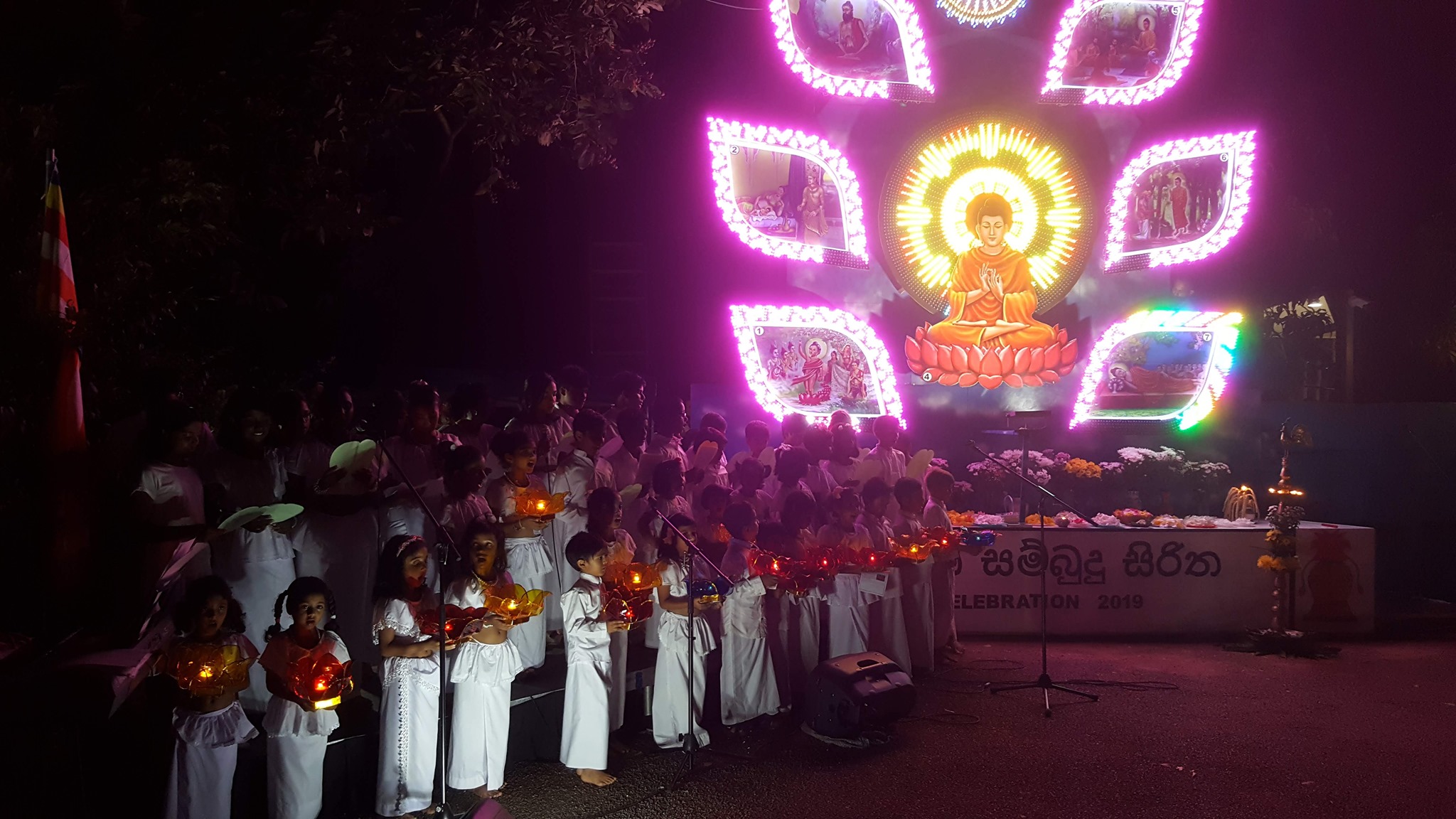Vesak celebration with students holding lamps